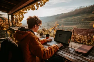 The Rise of Digital Nomad Hotspots: What Makes a City Ideal for Remote Work? a young digital nomad working remotely from a dreamy location